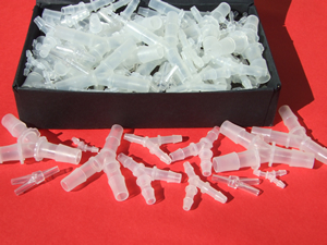 Y connectors for joining plastic tube and hose in a black display box.
