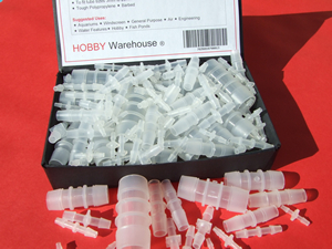 Straignt plastic tube and hose connectors barbed in a black display box.