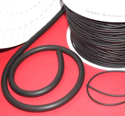 Rubber cord (neoprene) on a white spool/coil on a red background.